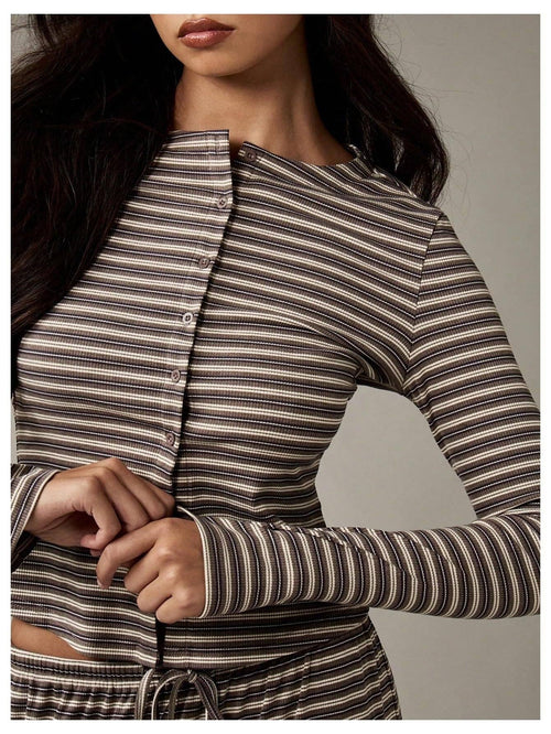 Woman wearing a striped long-sleeve top against a neutral background