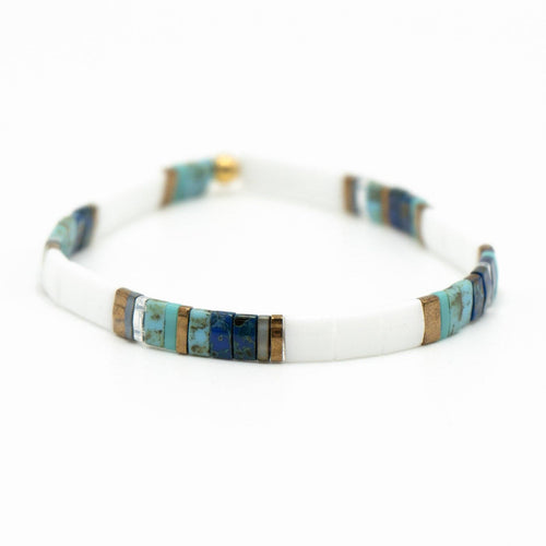 Bracelet with white band and colorful inlay on a white background