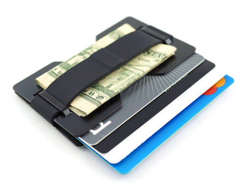 A black minimalist card holder wallet with a strap holding a stack of credit cards and a folded U.S.