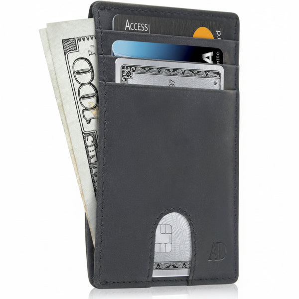 A slim black leather cardholder wallet shown open, filled with cash and sample credit cards, on a white background.