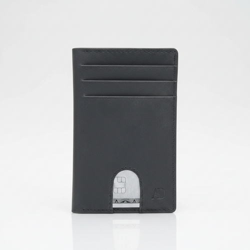 A minimalist black leather card holder wallet with multiple card slots and a silver metallic card partially visible through the cutout at the bottom, set against a clean white background.