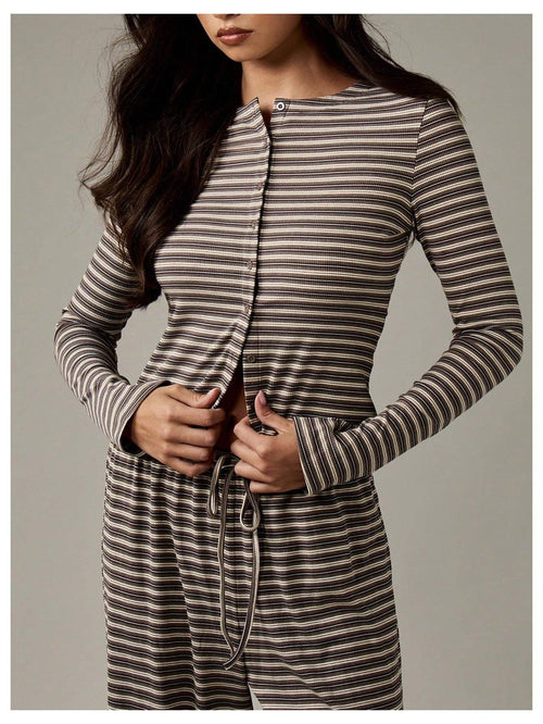 Woman wearing a striped long-sleeve dress against a neutral background