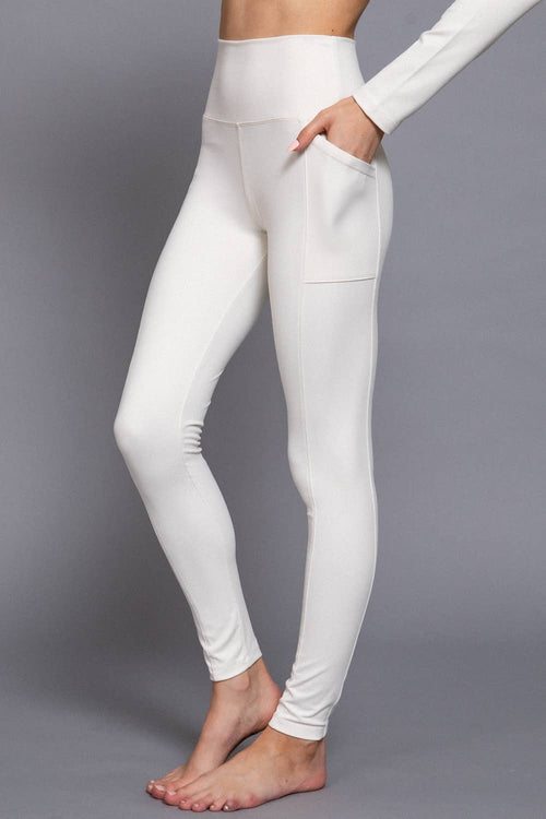 White leggings worn by a person on a gray background