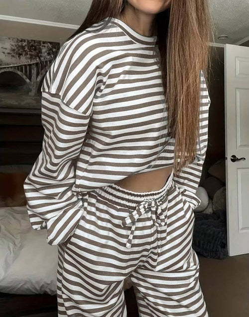 Person wearing a brown and white striped outfit in a room.