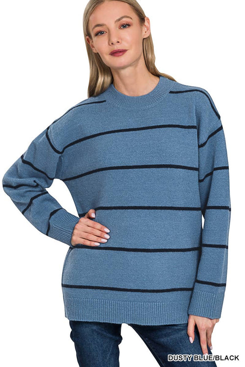 Woman wearing a blue sweater with black stripes on a white background
