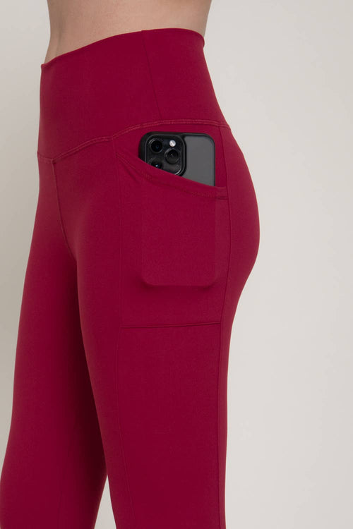 Red leggings with a pocket on a plain background