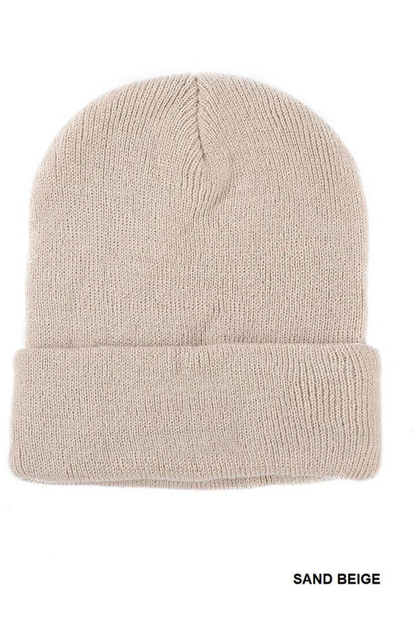 A knit beanie hat in a sandy beige color, shown from the front on a white background with 'SAND BEIGE' text in the bottom right corner.