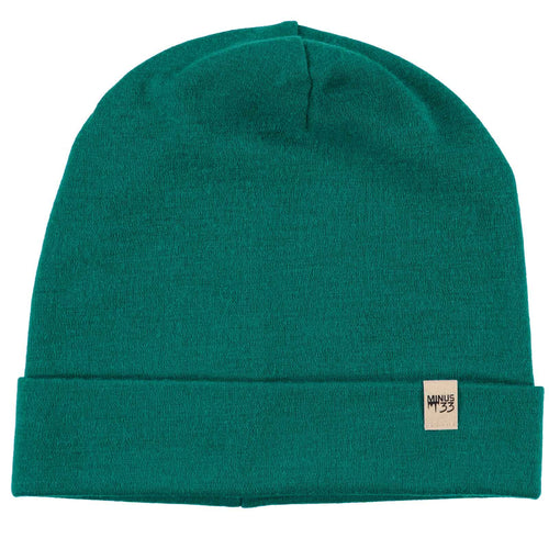 Green beanie with a brand label on a white background