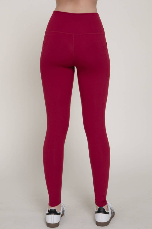 Red leggings worn by a person on a white background