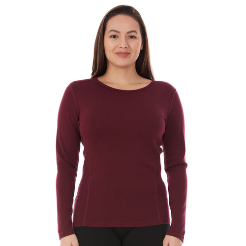Woman wearing a maroon long-sleeve shirt on a white background