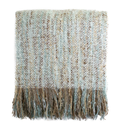 Textured blanket with fringes on a white background