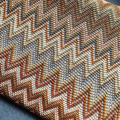Close-up of a fabric with a zigzag pattern in brown, beige, and gray.