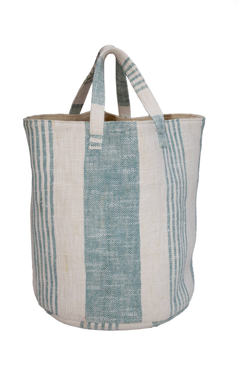 A woven jute tote bag with vertical stripes in light blue and off-white, featuring two top handles, shown against a plain white background.