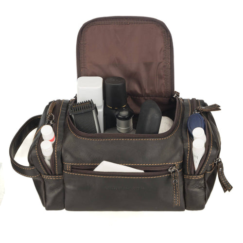 Brown leather bag with grooming products on a white background