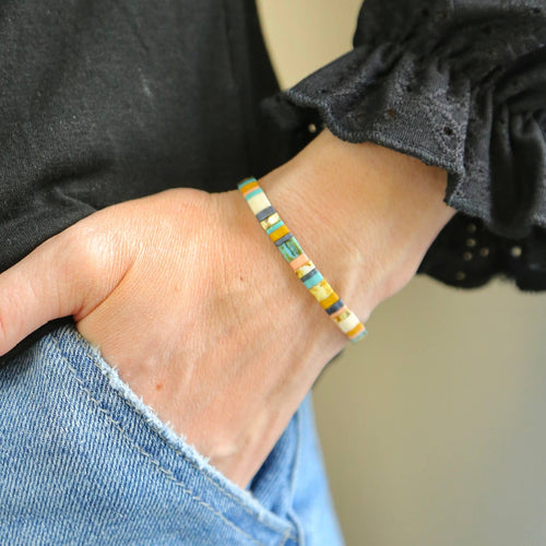 Colorful beaded bracelet on a wrist with a blurred background