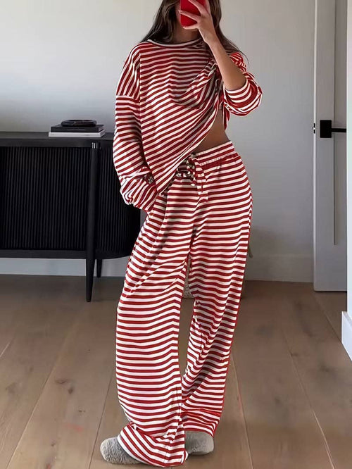 Person wearing a red and white striped outfit in a room.