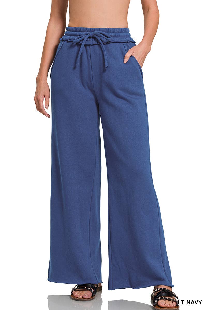 Blue wide-leg pants worn by a person on a white background