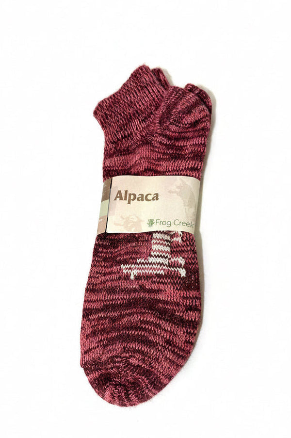 Maroon alpaca sock with a label on a white background