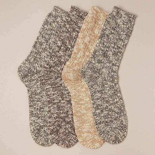 Two pairs of marled socks in gray and beige on a beige background