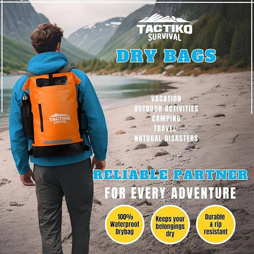 Person wearing an orange Tactiko Survival dry bag on a beach with scenic mountains in the background.