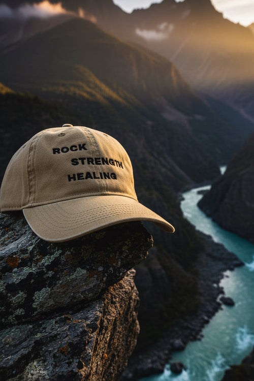 Beige cap with 'Rock Strength Healing' text Mountain background