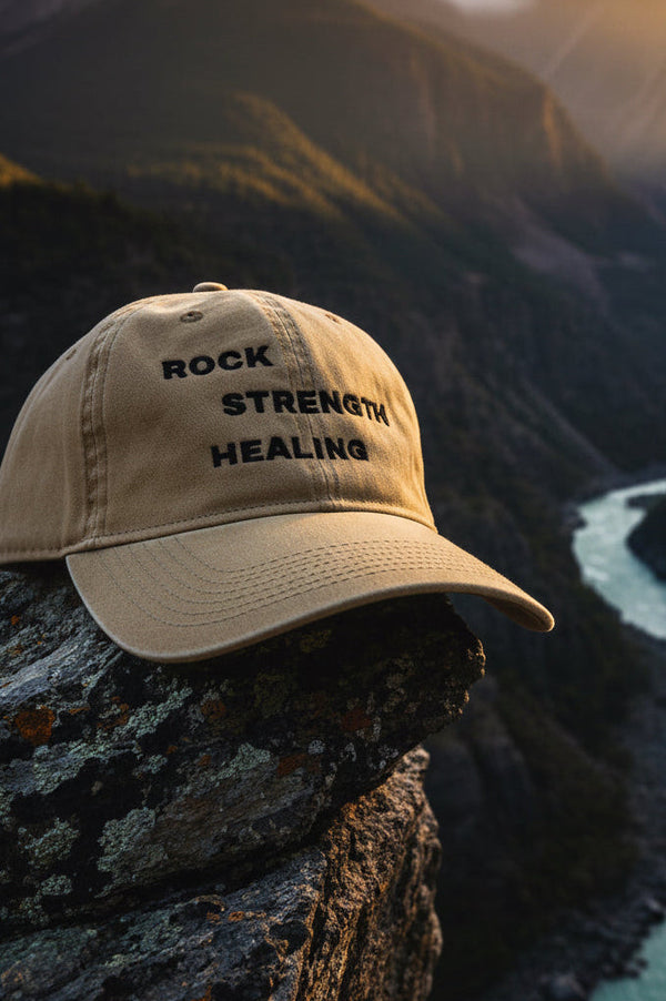Beige cap with 'Rock Strength Healing' text Mountain background