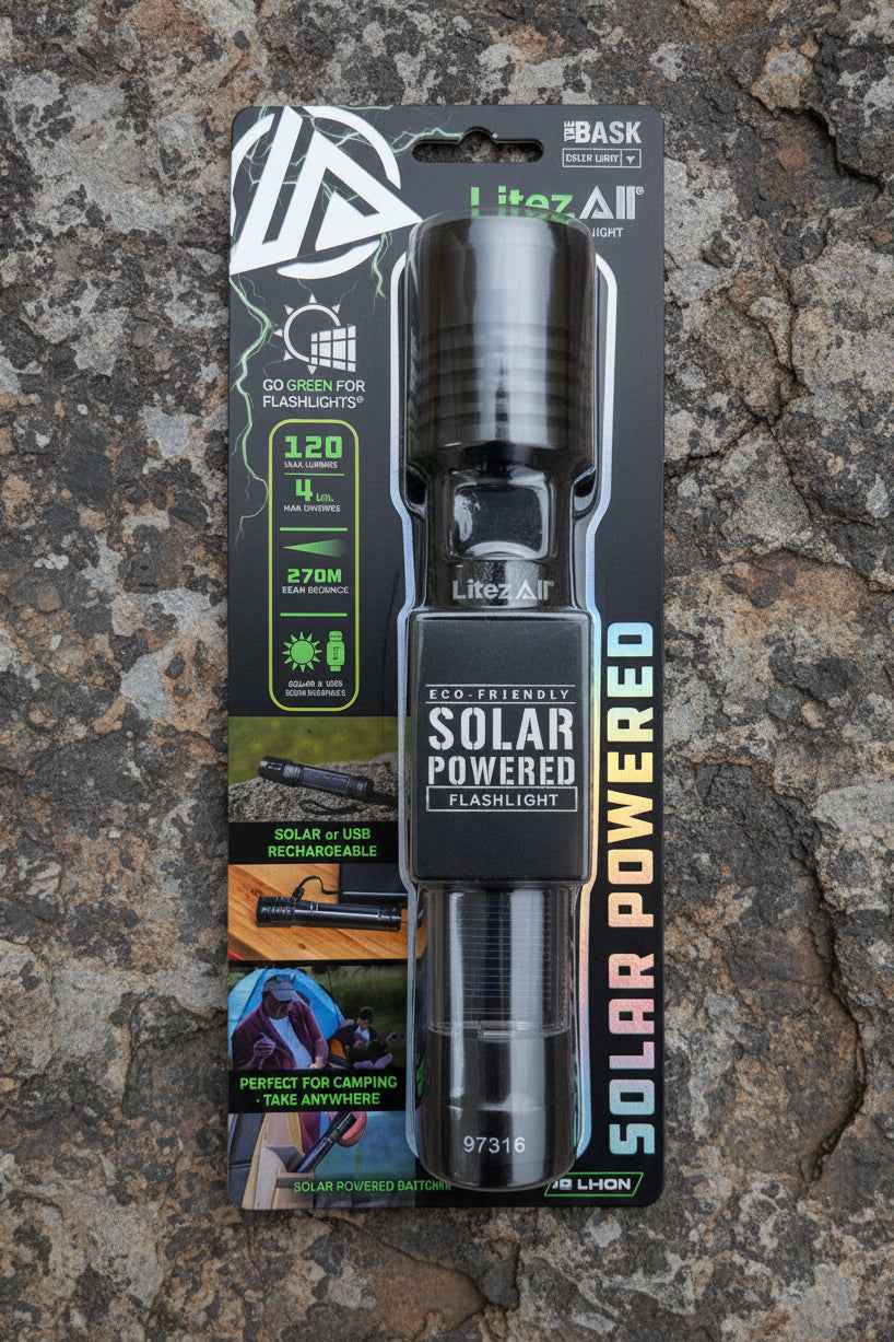 Solar-powered flashlight in packaging on a rocky surface
