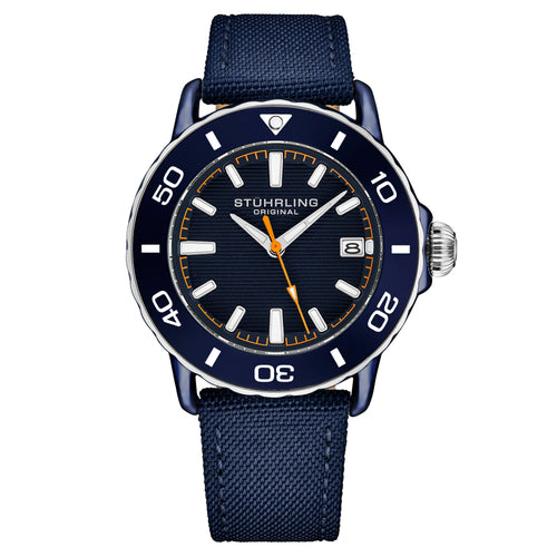 A Stuhrling Original analog watch with a dark blue dial, a matching blue rotating bezel with white markings, a silver-tone stainless steel case, and a textured navy blue fabric strap.