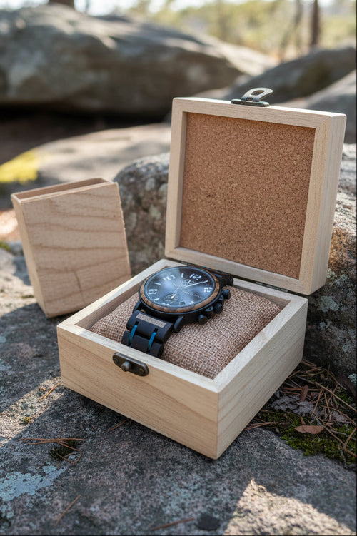 Watch with blue face and black strap in a wooden box