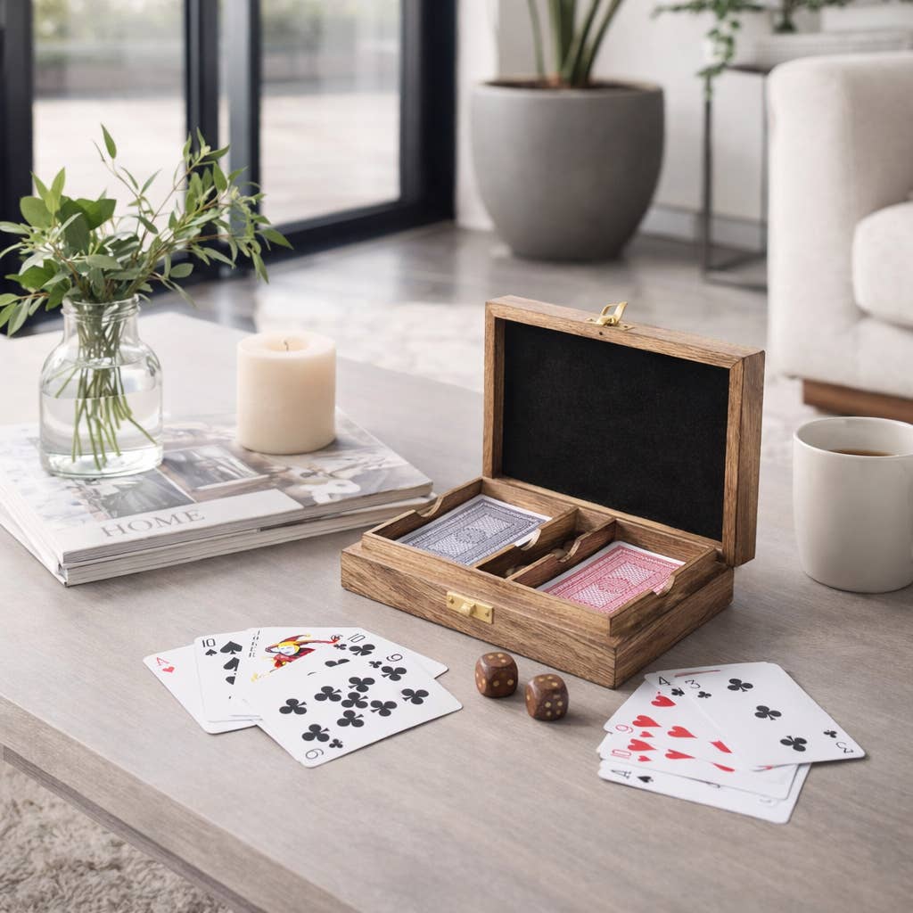 Wooden playing card set with cards and dice on a table in a living room setting.