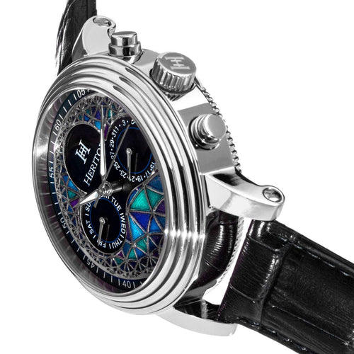 Luxury watch with intricate design and black leather strap on a white background