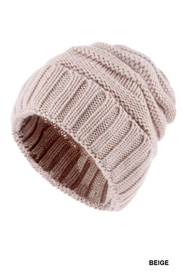 A ribbed knit beanie hat in a light beige color, shown on a plain white background with the word 'BEIGE' printed in the bottom right corner.