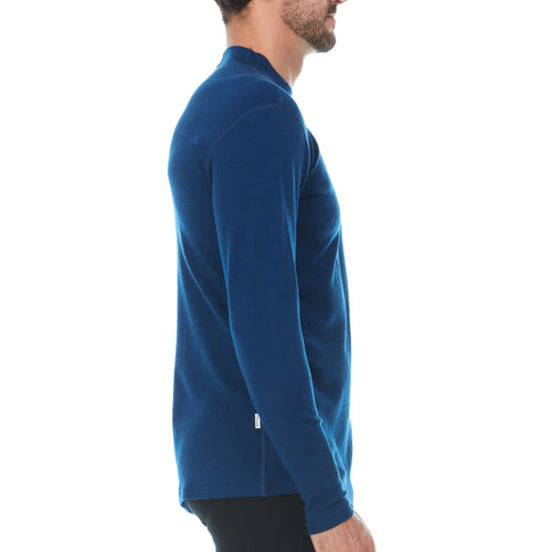 Man wearing a blue long-sleeve shirt on a white background