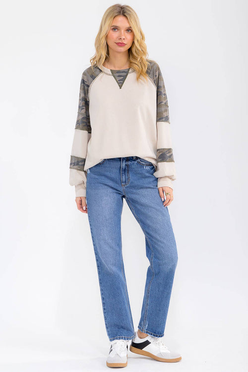 Woman wearing a plaid shirt and blue jeans on a white background