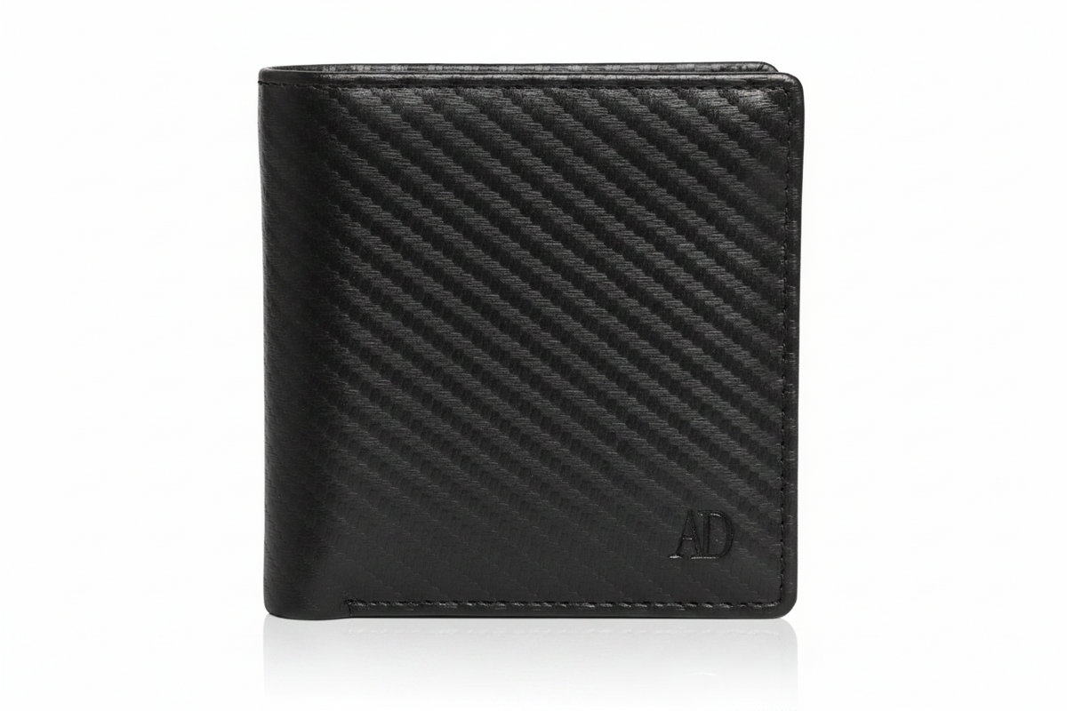 A black leather bifold wallet with a textured diagonal carbon-fiber-like pattern and a small debossed 'AD' logo in the bottom right corner, shown on a white background with a soft reflection.