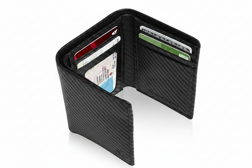 A black carbon fiber-textured bi-fold wallet shown open, displaying multiple card slots filled with sample credit cards, on a clean white background.