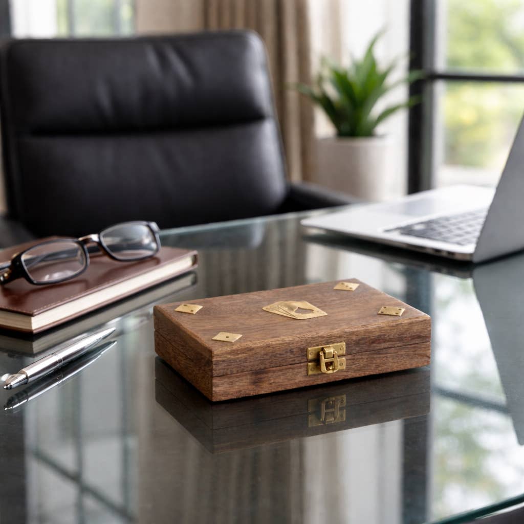 Wooden box with gold accents on a glass desk in an office setting