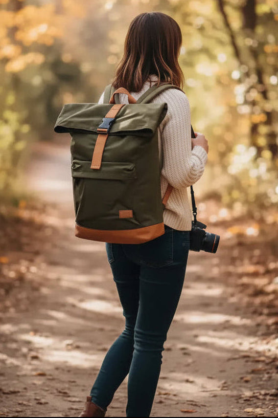 Woman with camera and backpack walking on autumn forest path, golden leaves, natural world photography