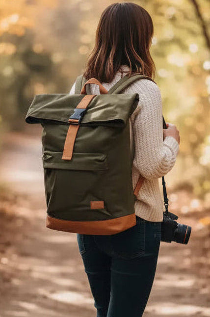 Woman with camera and backpack walking on autumn forest path, golden leaves, natural world photography