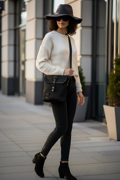 Black canvas crossbody bag with leather strap and metal hardware