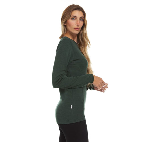 Woman wearing a green long-sleeve top on a white background