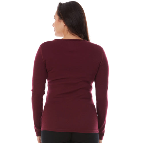 Woman wearing a maroon long-sleeve shirt on a white background