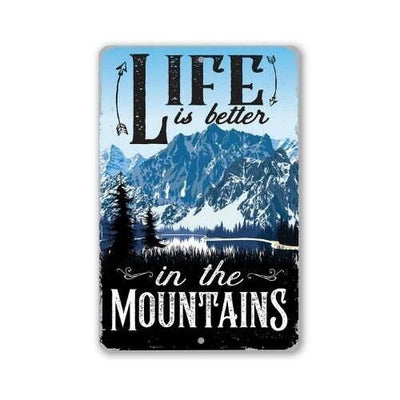A rectangular metal sign with rounded corners featuring a mountain landscape and the text 'LIFE is better in the MOUNTAINS' on a white background.