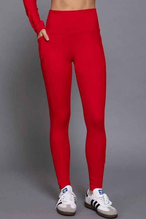 Red leggings worn by a person on a gray background