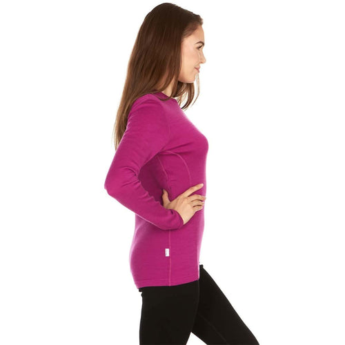 Woman wearing a bright pink long-sleeve top on a white background
