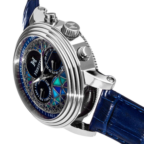 Luxury watch with blue strap and intricate face design on a white background
