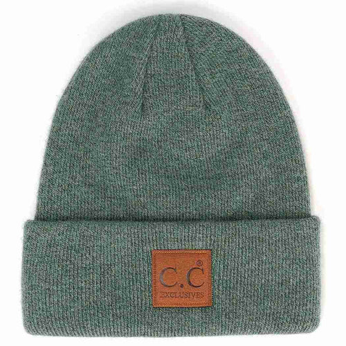 Green beanie with a brown leather patch on a white background